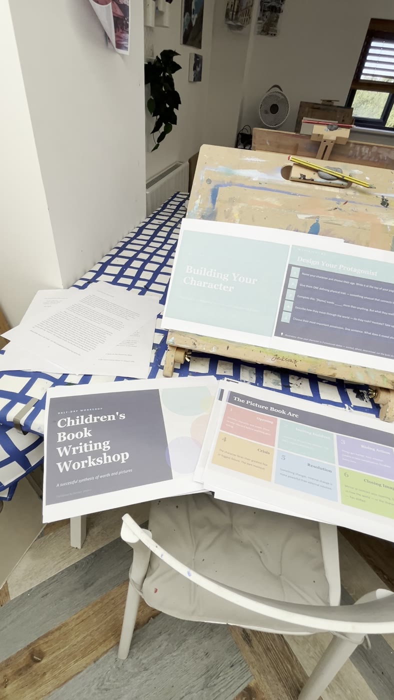 The printed Children's Book Writing Workshop handout on the table