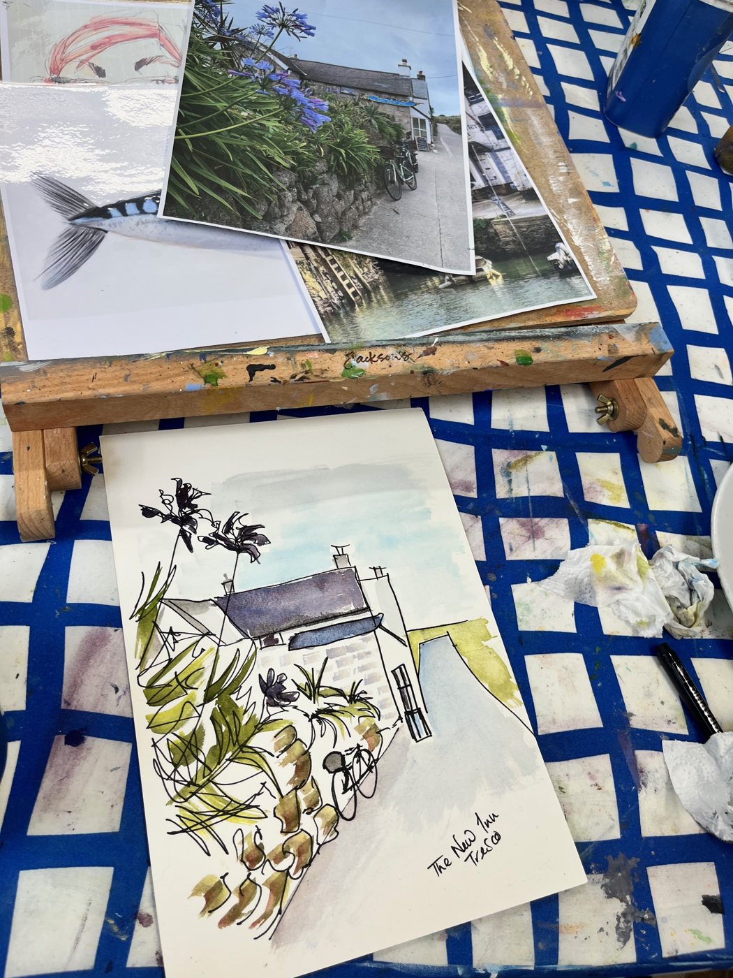 A journal page: a cottage and plants in ink and wash