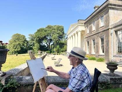 An easel set up on the terrace by the house