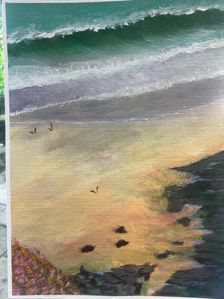 Roger's beach scene from above: tiny walkers and dogs on wet sand, surf beyond, thrift in the foreground