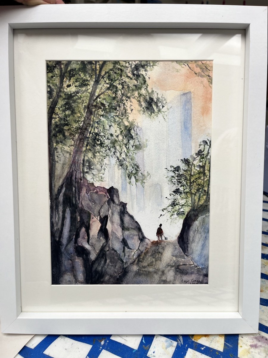 Roger’s framed watercolour: a lone figure on a rocky path, trees overhead, mist beyond