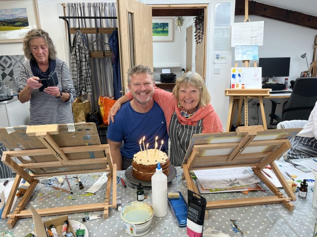 Damian with a student celebrating in the studio